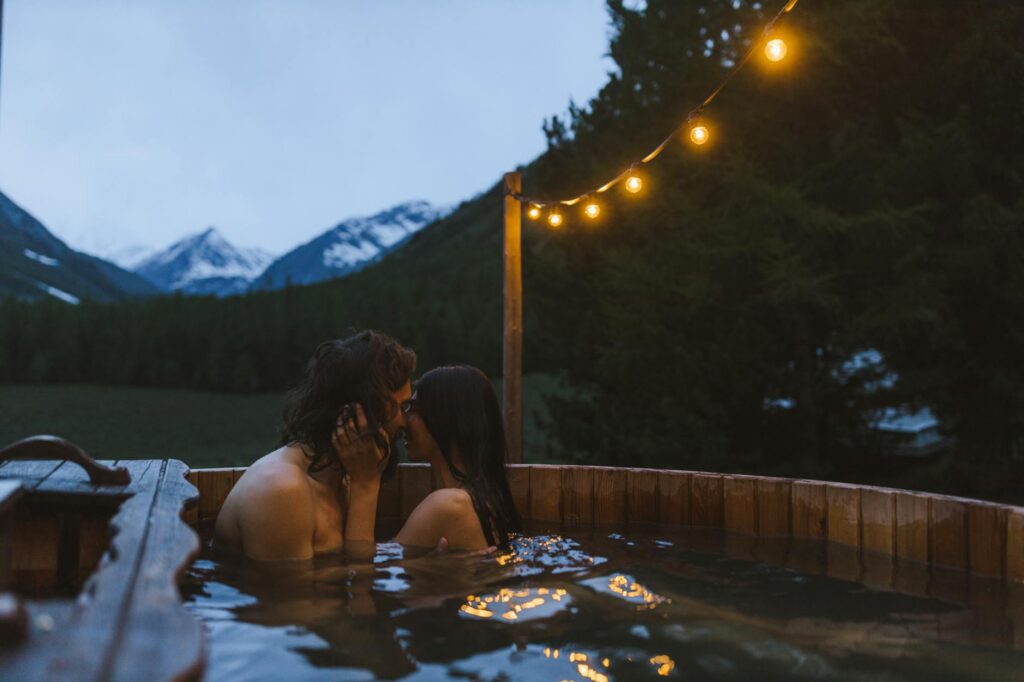 Couple relaxing in a private hot tub at night - Romantic Getaway Near Zion National Park