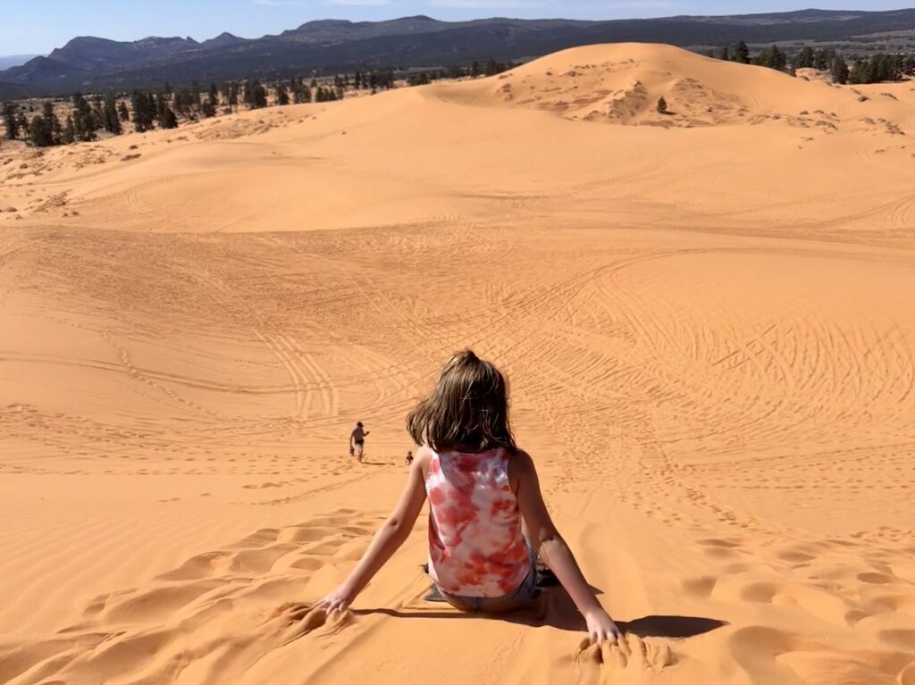 Sand sledding down the dunes at Coral Pink Sand Dunes State Park - Zion's Tiny Getaway