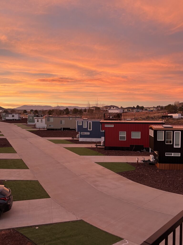 Tiny homes at Zion's Tiny Getaway under a sunset sky in Apple Valley, Utah